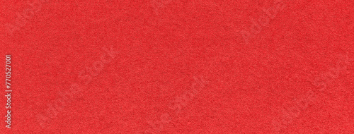 Texture of old bright red color paper background, macro. Structure of a vintage craft scarlet cardboard.