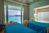 Luxury spa in over water villas. Tropical outdoor design. Idyllic tourism beach scene massage beds and seascape view. Inspirational sunny travel wellbeing wellness interior design. Meditation inspire