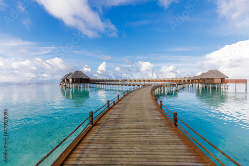 Fototapeta Naklejka Na Ścianę i Meble -  Maldives water villas paradise background. Tropical landscape, seascape with long pier, water villas, amazing sea sky and lagoon beach, tropical nature. Exotic tourism destination, summer vacation