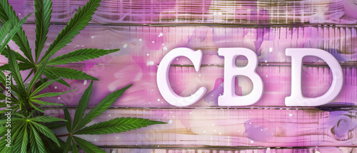 Cannabis leaf with cbd text on artistic pink painted wood