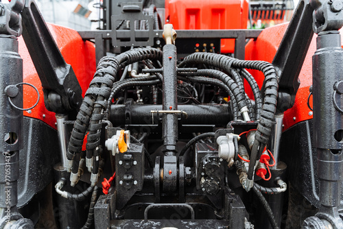 Close up of red and black vehicle with engineering parts like valves and nuts