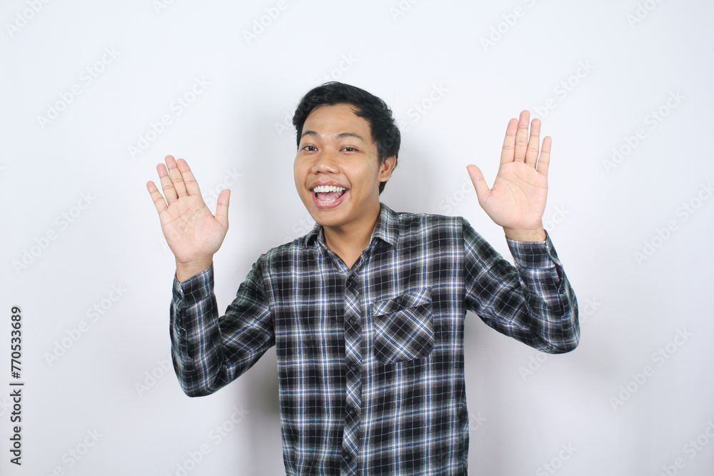 cheerful asian man say hello with waving two hands isolated on white background