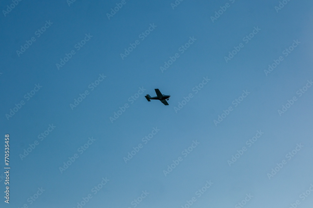 small plane in the blue sky