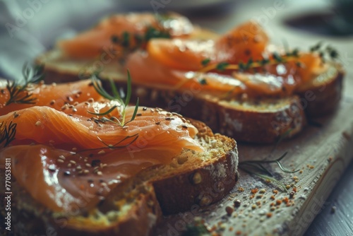 Close-up of smoked salmon on crusty bread adorned with fresh herbs.