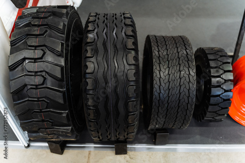 Various tires displayed on shelf for different vehicles