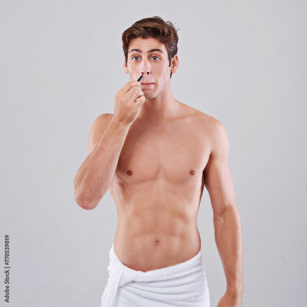 Fototapeta premium Tweezer, nose and man on gray background for wellness, hair removal and beauty treatment in studio. Skincare, dermatology and isolated person with health tools for cosmetics, grooming and hygiene
