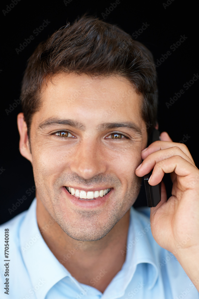 Obraz premium Phone call, smile and businessman in portrait in studio, speaking on mobile conversation, business deal or networking. Consultant or man, communication and connect with smartphone on black background