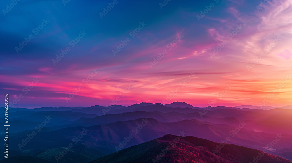 A breathtaking view of a mountain range at sunset with vibrant colors painting the sky.