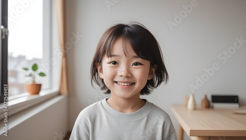 Portrait of cute Asian kid, child, on a plain white background. Simple home setting