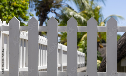 White wooden fence in the garden. Selective focus and small depth of field. photo