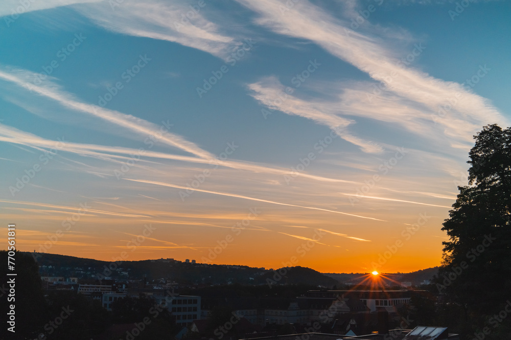 Sun peaking over the horizon silhouette