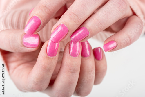 Stylish fashionable women's pink manicure closeup. © svdolgov