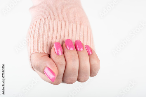 Close-up of woman's hand with stylish pink manicure with glitter. © svdolgov
