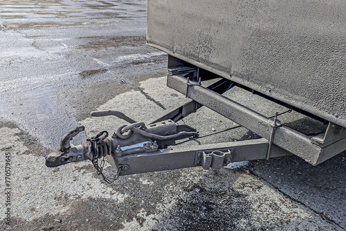 Tow bar of a cargo trailer in the parking lot on a winter day photo