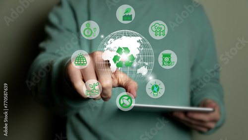 Climate change to limit global warming and sustainable development and green business concept. Businessman with green world and renewable energy icons.