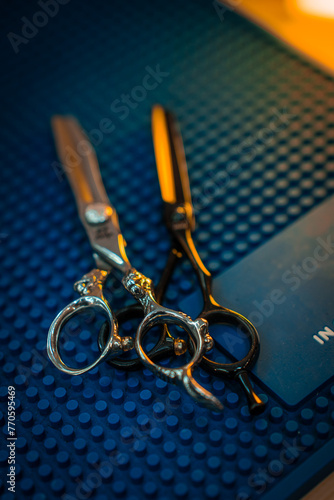 Barber scissors lie on a blue background