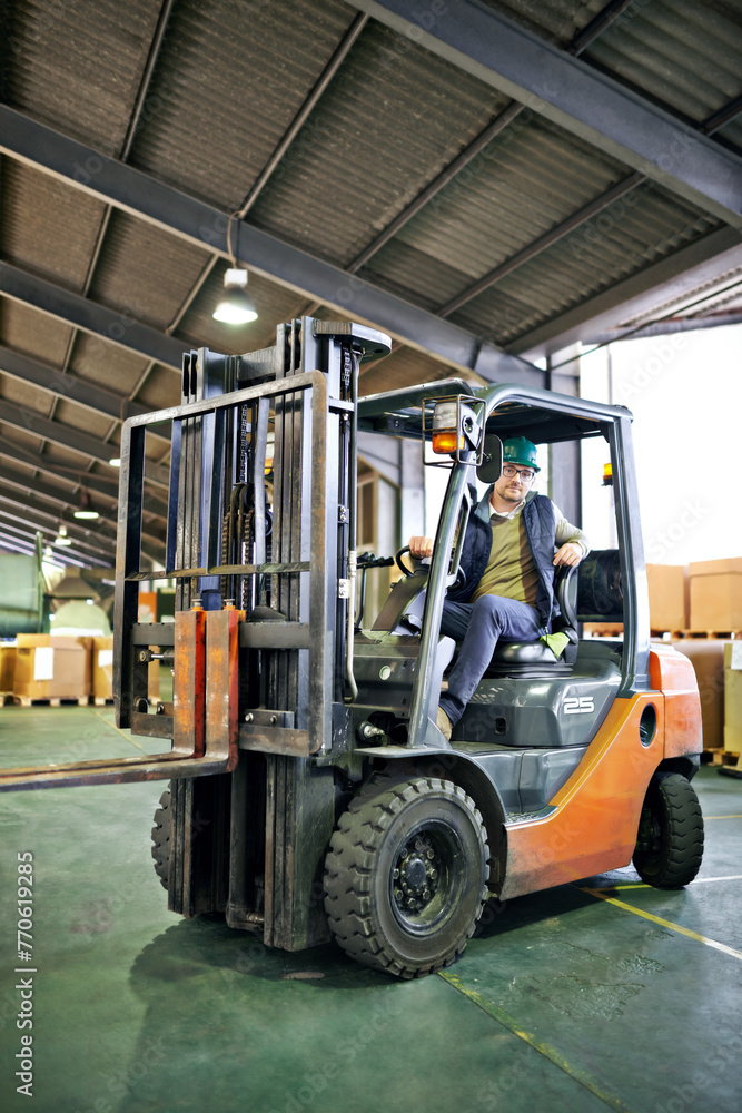 Driver, warehouse and man with forklift working on site, loading on dock with Industrial moving vehicle. Transporting, shipping inventory with safety hardhat for delivery, labor worker for company