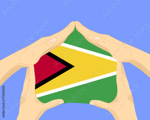 Hand home with Guyana flag, residential or investment idea, housing and home concept