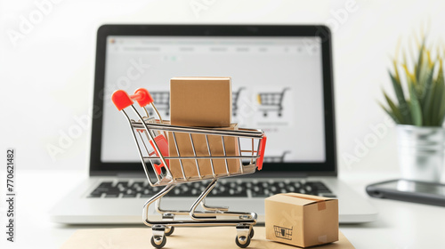 Online e-commerce concept with shopping cart full of boxes on top of laptop computer isolated on a white background with green plants