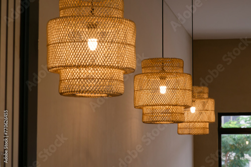 Rattan Radiance: Yellow-Glowing Ceiling Lamps Illuminate a Cozy Tea Shop with a Backdrop of Verdant Trees