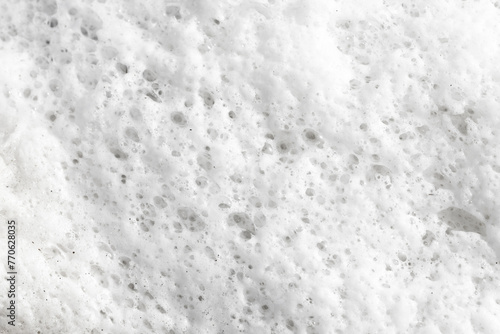 Soap bubbles texture. Black teflon frying pan cleaning. White suds pattern. Liquid detergent foam. Closeup shampoo bubbles. Washing dishes background. White foam on lake surface closeup structure. photo