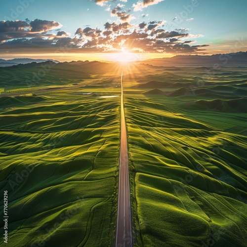 Dawn's first light over a straight country road, leading through green farmland in Xinjiang, China