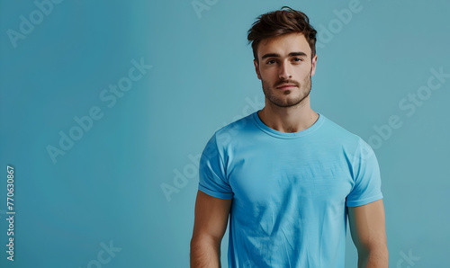 Handsome young man in blue t-shirt on blue background