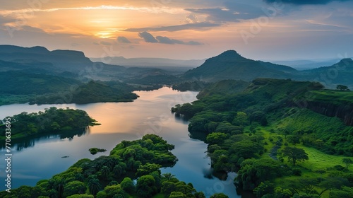 Aerial view of a misty tropical rainforest with lush greenery surrounding a winding river.