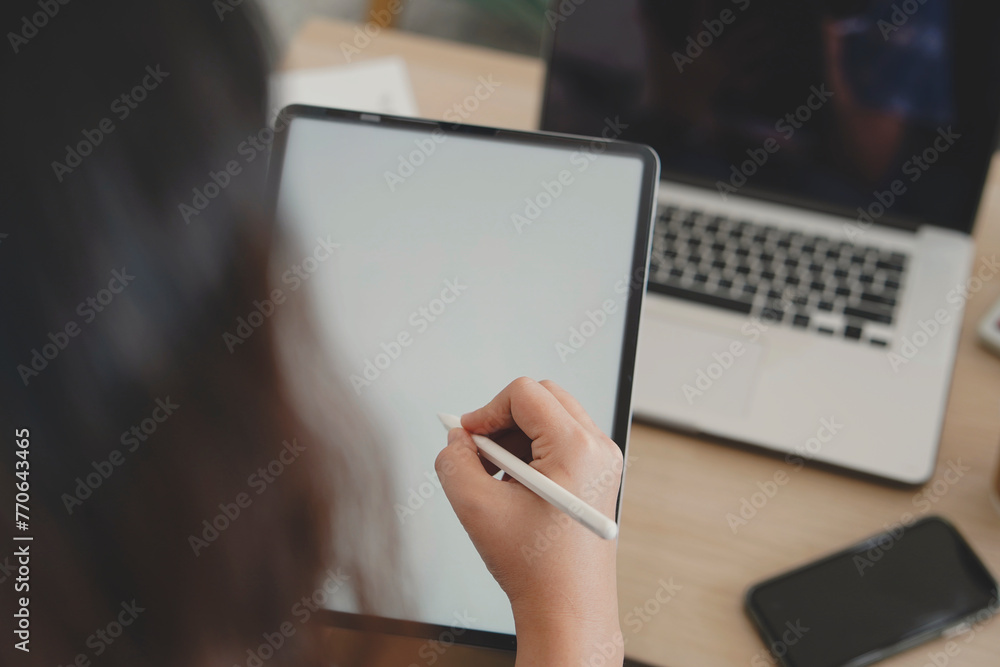 Fototapeta premium person typing on a digital tablet