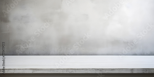  A close up of a concrete bench against a wall with a wooden floor  Gray wall and floor background