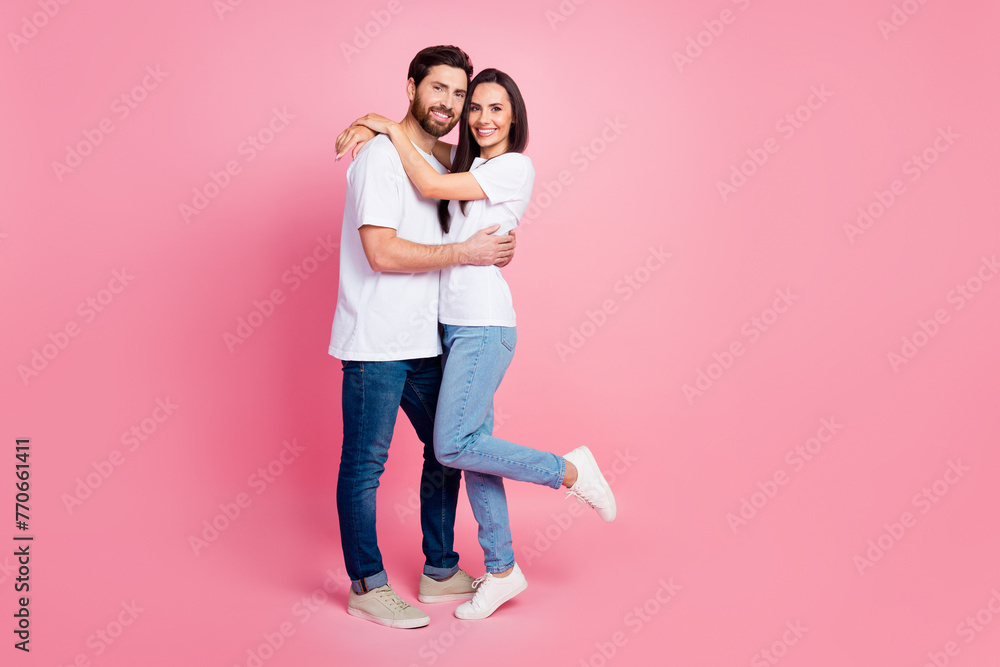Full body photo of nice young couple hugging care each other dressed stylish white outfit isolated on pink color background Full body photo of nice young couple hugging care each other dressed stylish white outfit isolated on pink color background