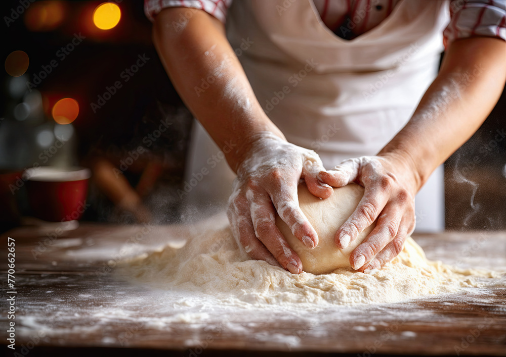 Female hands kneading dough on table in kitchen, closeup