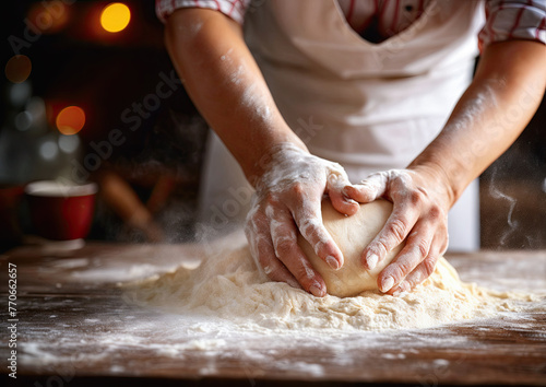 Female hands kneading dough on table in kitchen, closeup