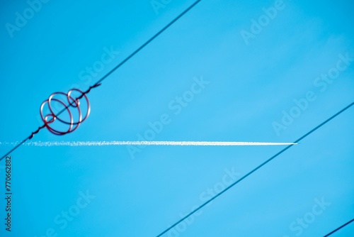 Low angle of an airplane track seen through metal wires