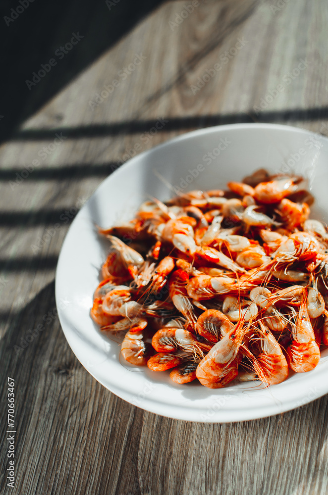 Azov shrimps boiled on a plate daylight from the window Azov shrimps boiled on a plate daylight from the window