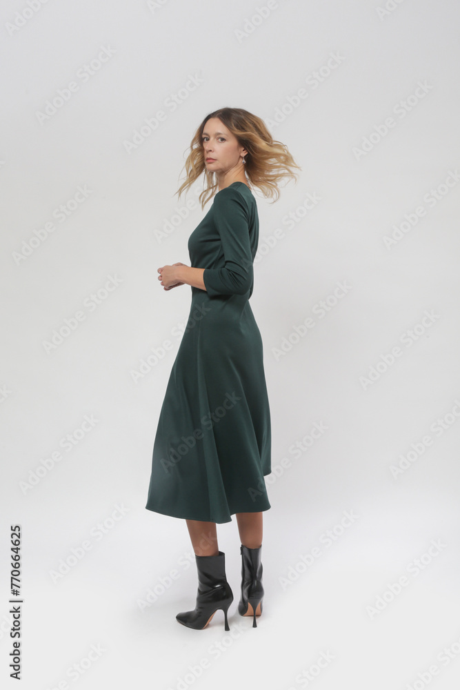 Serie of studio photos of young female model wearing green dress Serie of studio photos of young female model wearing green dress