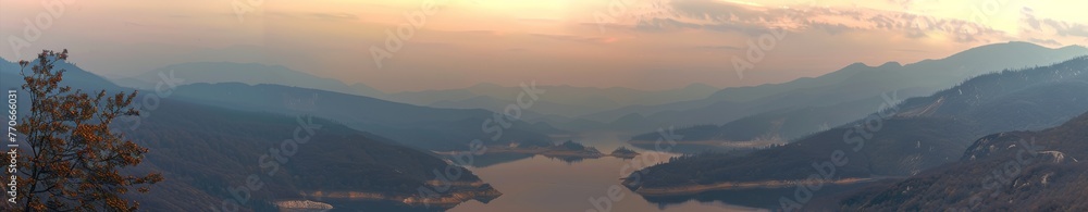 A mountain range with a lake in the foreground and a sky in the background