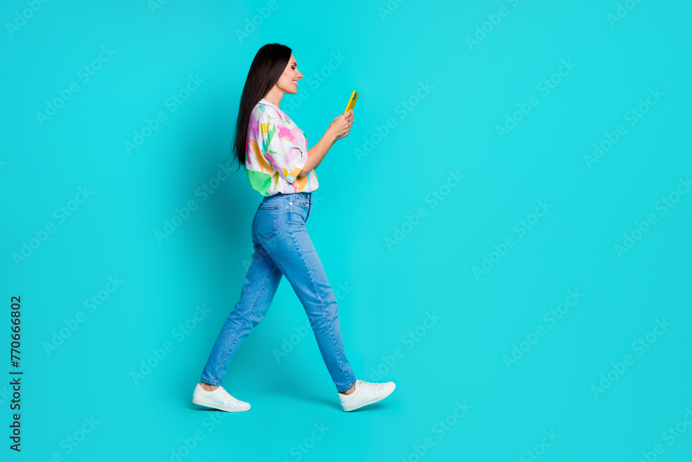 Photo of cheerful lovely woman blogger wear trendy print clothes chatting writing reading isolated on cyan color background