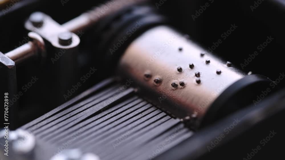 Spinning cylinder of the music box in closeup. Musical mechanism. Spinning cylinder of the music box in closeup. Musical mechanism.