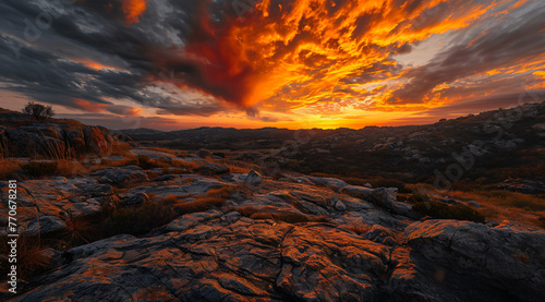 an orange and red sky is seen over a rocky area in the  9247d873-4c2a-428b-8ee0-fea9e56babab photo