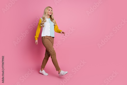 Full body profile photo of lovely pretty lady look walk empty space ad isolated on pink color background