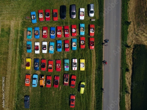 Line of vehicles parked in a parking lot, illustrating uniformity and consistency photo