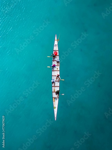 Aerial top view of a sailboat in a turquoise sea © Wirestock