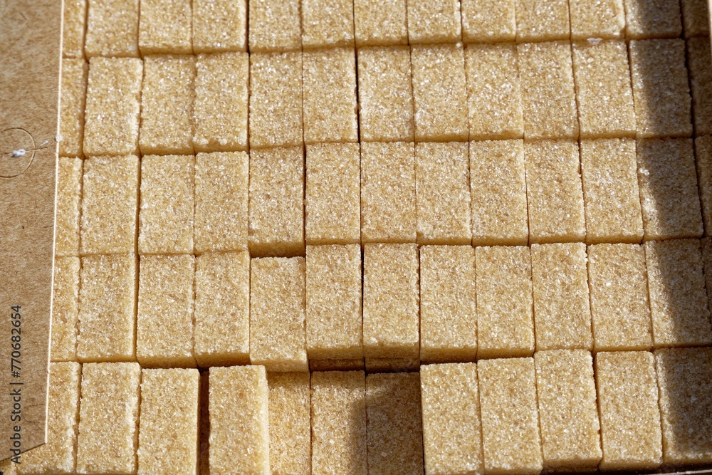 Close-up of a cardboard box filled to the brim with sugar cubes Close-up of a cardboard box filled to the brim with sugar cubes