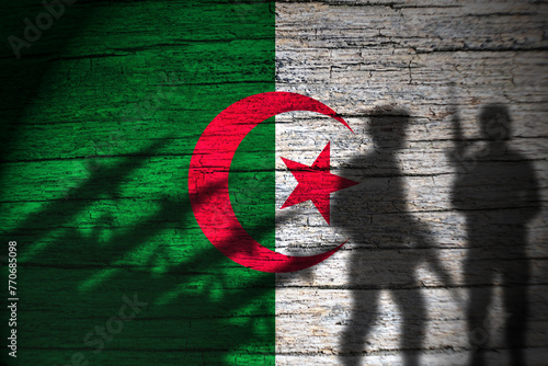 Algeria flag on wood and soldiers shadow photo