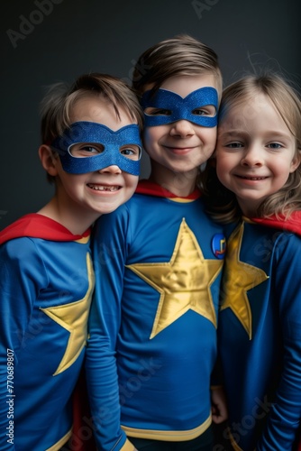 Portrait of a happy, laughing and smiling children dressed in superhero costumes and masks. Celebration of carnival, party, Halloween, and the Jewish holiday of Purim.