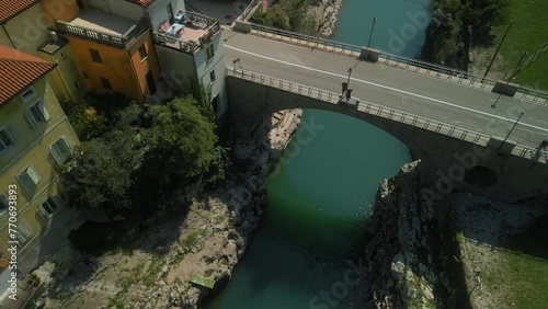 Drone footage of cars driving on Most Kanal Bridge crossing Soca River in Kanal ob Soci, Slovenia photo