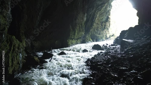 Drone footage of water flowing in Weaver Cave during daytime in Rakov Skocjan Valley, Slovenia photo