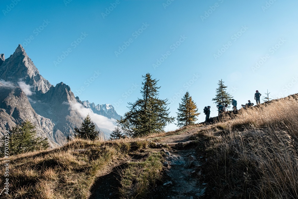 Beautiful shot of people on the scenic Tour du Mont Blanc trail in Europe Beautiful shot of people on the scenic Tour du Mont Blanc trail in Europe