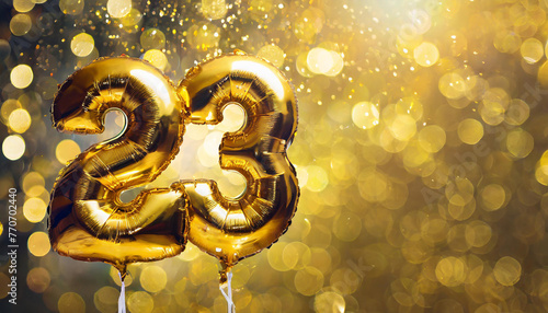 Banner with number 23 golden foil balloon. Twenty three years anniversary celebration. Golden bokeh